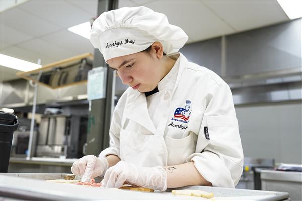 Culinary Arts and Science student working in kitchen 